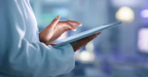 Doctor, researcher, or scientist searching for information on the Internet on a tablet while working in a laboratory, scientific institution, or hospital