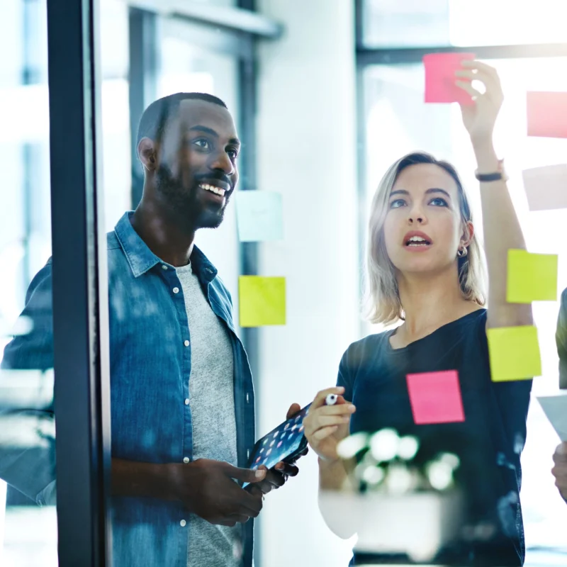 happy team is working foccussed on business strategy notes on glass wall